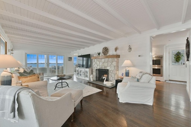 living room featuring a fireplace, dark wood-type flooring, and beamed ceiling