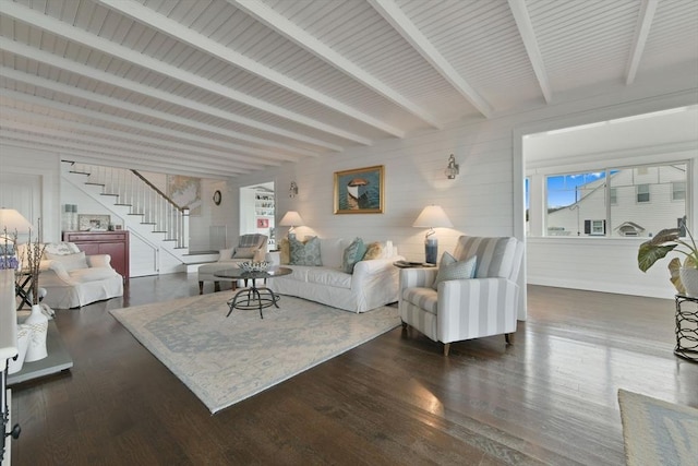 living room with dark hardwood / wood-style flooring and beamed ceiling