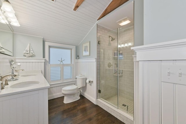 bathroom with vaulted ceiling, hardwood / wood-style floors, vanity, a shower with shower door, and toilet