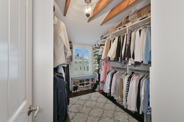 spacious closet featuring beam ceiling