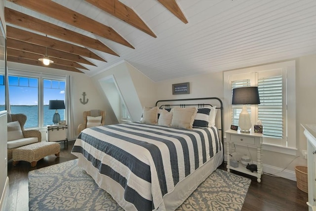 bedroom featuring dark hardwood / wood-style flooring, beamed ceiling, and a water view