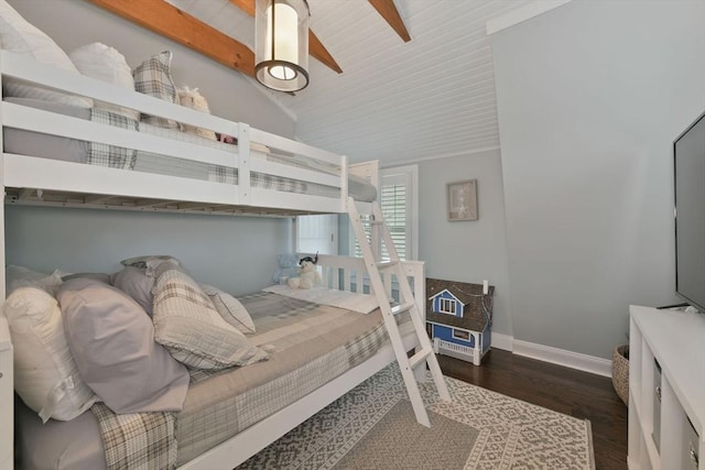 bedroom featuring dark wood-type flooring and lofted ceiling with beams