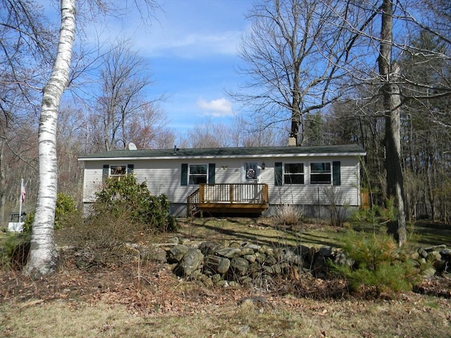 manufactured / mobile home featuring a chimney and a deck