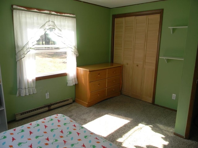 bedroom with carpet flooring, baseboard heating, and a closet