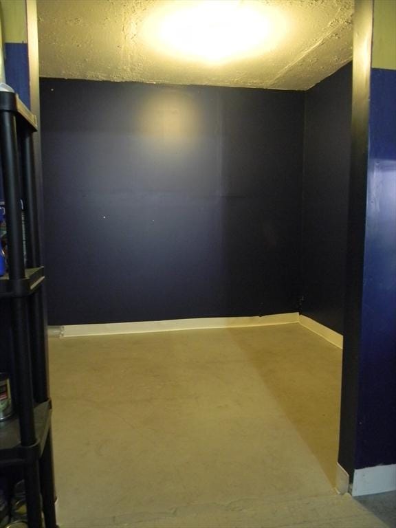 unfurnished room with baseboards