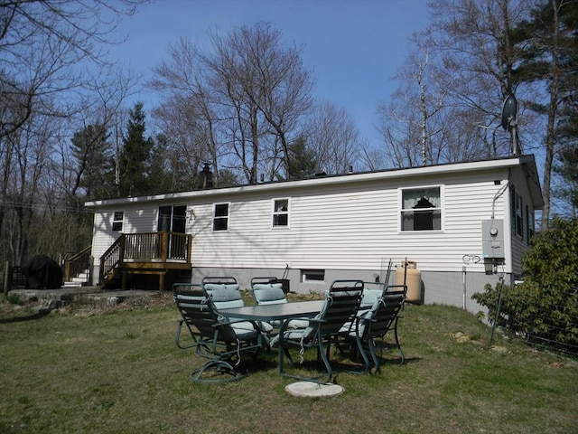 back of house with a yard and a wooden deck