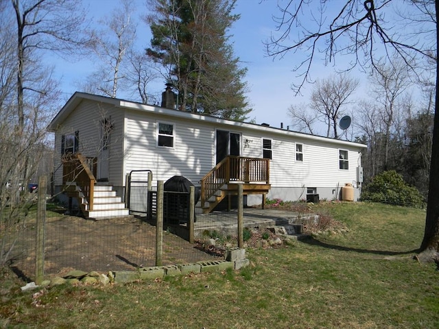 rear view of property featuring a yard and a chimney