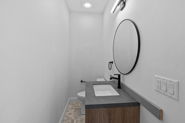 bathroom with vanity and toilet