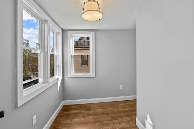 spare room with dark hardwood / wood-style floors