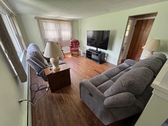 living room featuring wood finished floors and baseboards