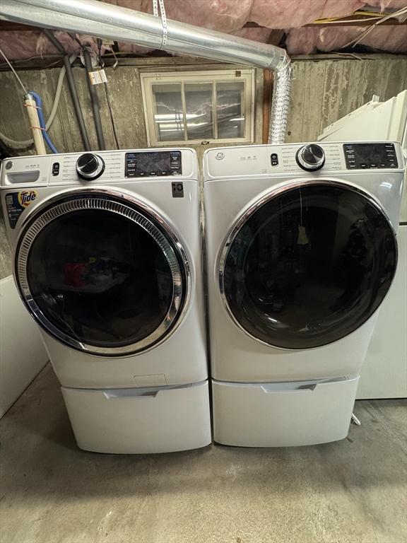 clothes washing area featuring separate washer and dryer