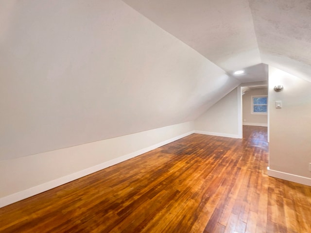 bonus room with vaulted ceiling and hardwood / wood-style floors