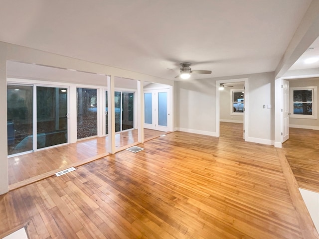 unfurnished living room with ceiling fan and light hardwood / wood-style floors