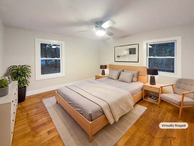 bedroom with hardwood / wood-style floors and ceiling fan