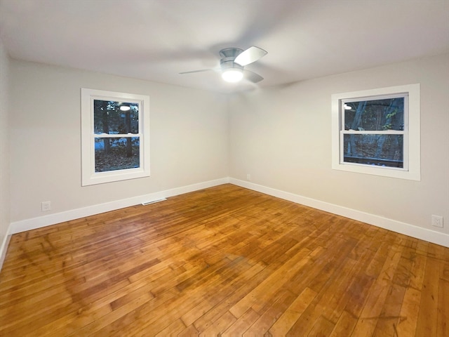 empty room featuring wood-type flooring and ceiling fan