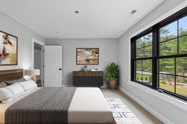 unfurnished room featuring vaulted ceiling and light wood-type flooring