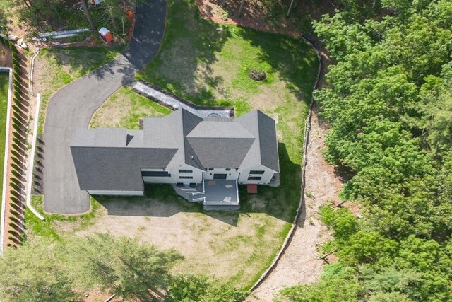 rear view of property featuring a wooden deck and a yard