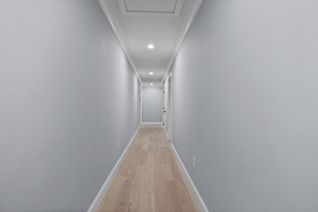 hall featuring light hardwood / wood-style floors and ornamental molding