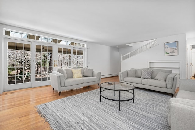 living room featuring light hardwood / wood-style flooring and a baseboard radiator