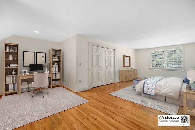 bedroom featuring a closet and light wood-type flooring