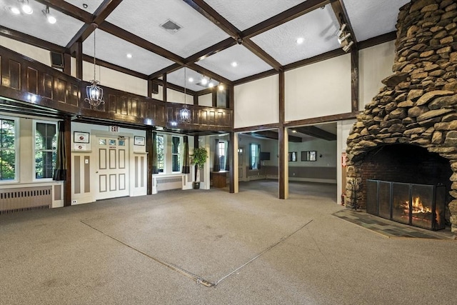 51 Tamarack Ln Unit 51, Peabody, MA 01960 - unfurnished living room featuring radiator heating unit, carpet floors, a fireplace, beamed ceiling, and coffered ceiling