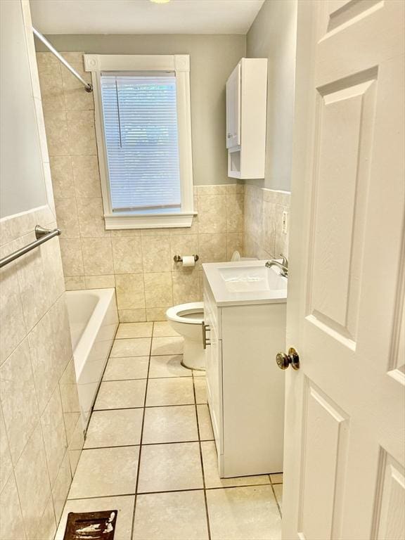 437 Ferry St Unit 1, Everett, MA 02149 - full bath with tile patterned flooring, tile walls, vanity, tub / shower combination, and wainscoting