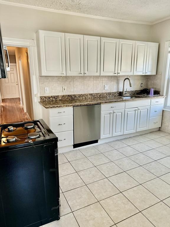 437 Ferry St Unit 1, Everett, MA 02149 - kitchen with stainless steel dishwasher, electric range, a textured ceiling, white cabinetry, and crown molding