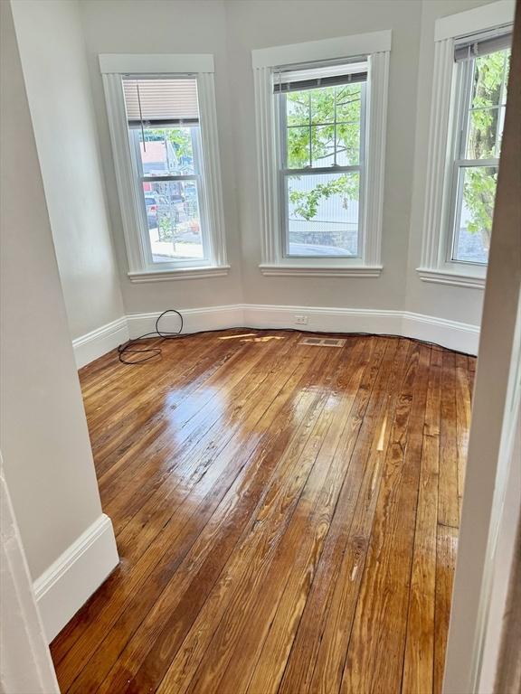 437 Ferry St Unit 1, Everett, MA 02149 - empty room featuring hardwood / wood-style flooring and plenty of natural light