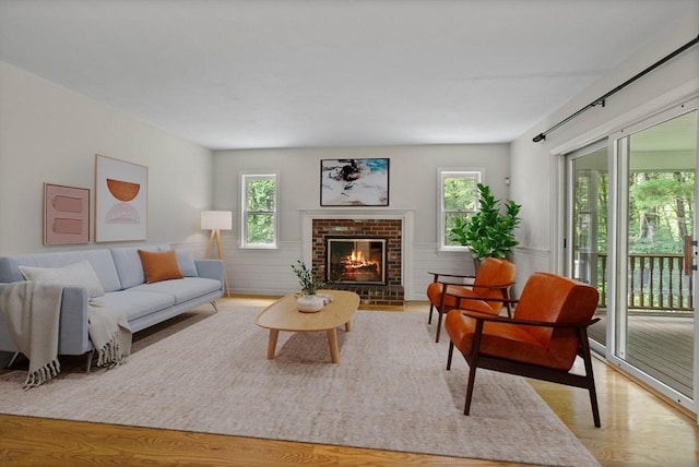 32 Twin Pond Ln, Sudbury, MA 01776 - living room with healthy amount of natural light, a brick fireplace, and light wood finished floors