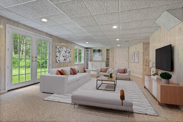 32 Twin Pond Ln, Sudbury, MA 01776 - living area with wooden walls, carpet floors, french doors, and recessed lighting