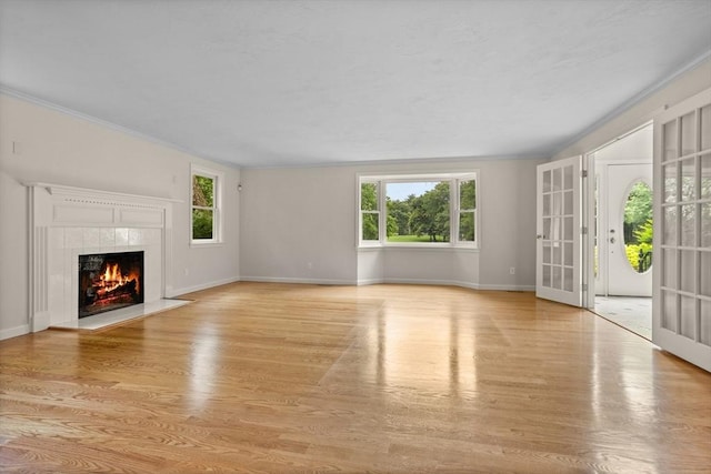 32 Twin Pond Ln, Sudbury, MA 01776 - unfurnished living room with light wood-type flooring, a fireplace, and crown molding