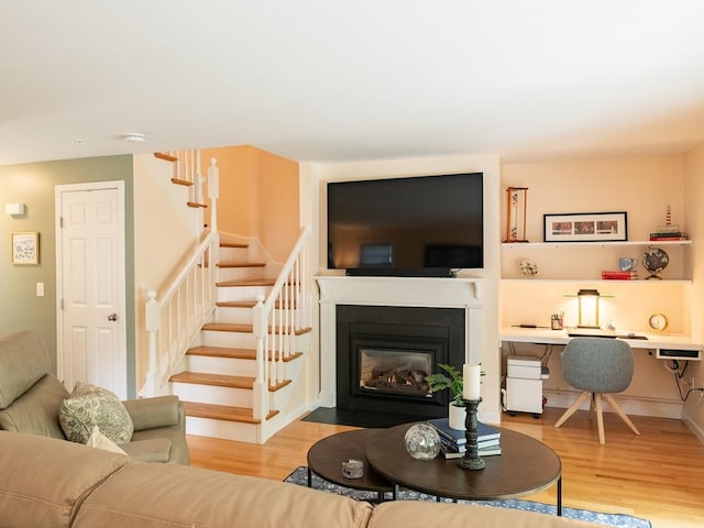 40 Bay Farm Unit 40, Duxbury, MA 02332 - living area with stairway, wood finished floors, and a fireplace with flush hearth