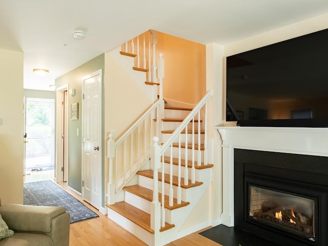 40 Bay Farm Unit 40, Duxbury, MA 02332 - stairway featuring wood finished floors and a glass covered fireplace