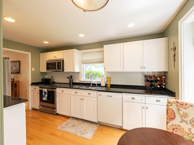 40 Bay Farm Unit 40, Duxbury, MA 02332 - kitchen with stainless steel appliances, light wood finished floors, decorative backsplash, white cabinetry, and recessed lighting