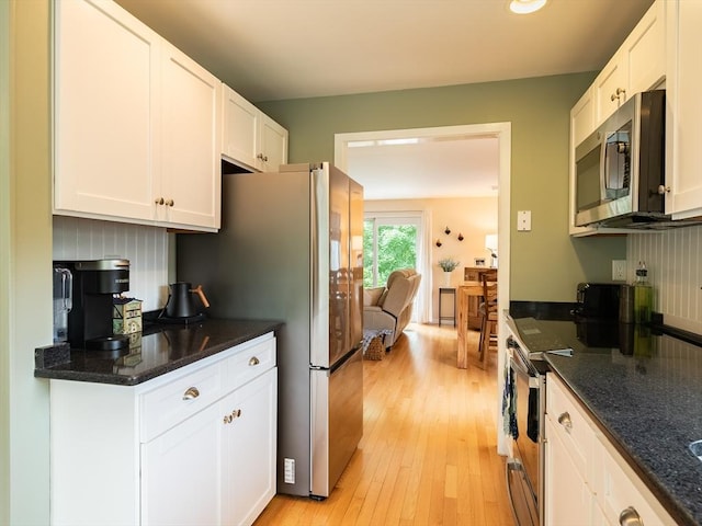 40 Bay Farm Unit 40, Duxbury, MA 02332 - kitchen featuring stainless steel appliances, light wood finished floors, white cabinets, and dark stone countertops