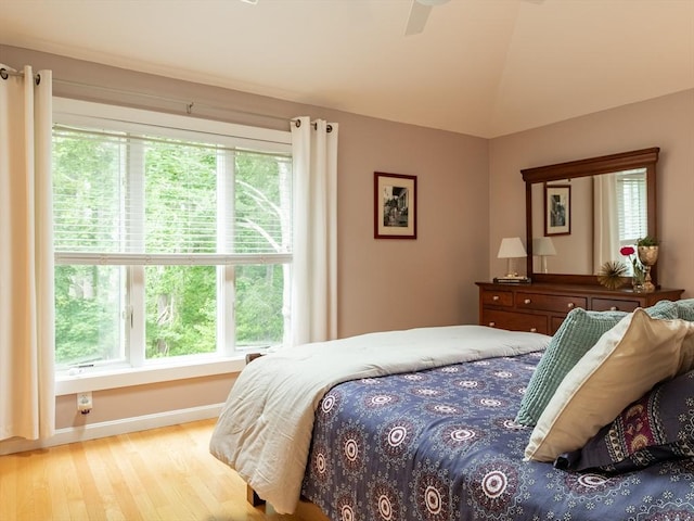 40 Bay Farm Unit 40, Duxbury, MA 02332 - bedroom featuring wood finished floors, multiple windows, vaulted ceiling, and ceiling fan