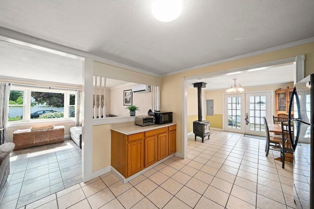 24 Hobson St, Brockton, MA 02302 - kitchen with a wood stove, open floor plan, light tile patterned floors, french doors, and light countertops