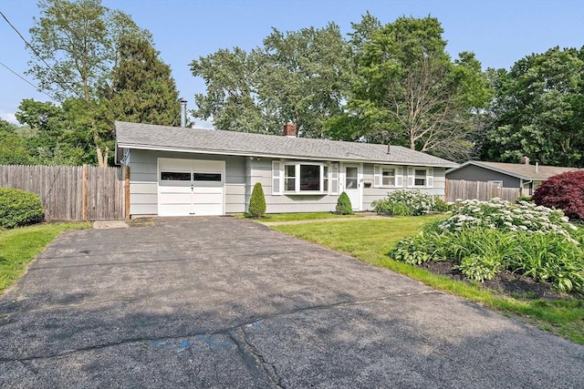 24 Hobson St, Brockton, MA 02302 - single story home featuring a garage, asphalt driveway, and a chimney