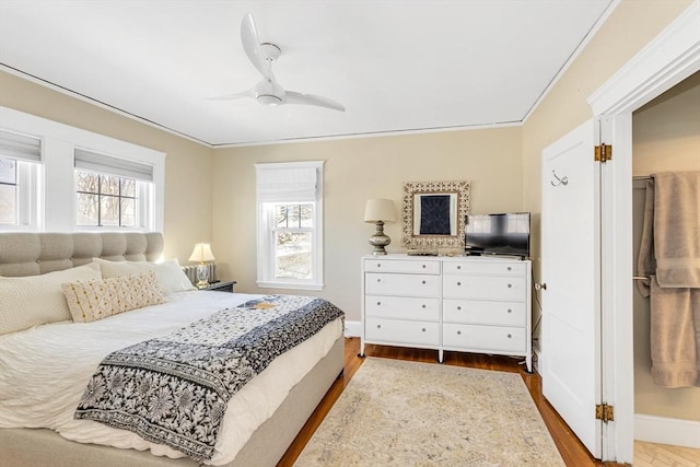 bedroom featuring ornamental molding, hardwood / wood-style floors, and ceiling fan