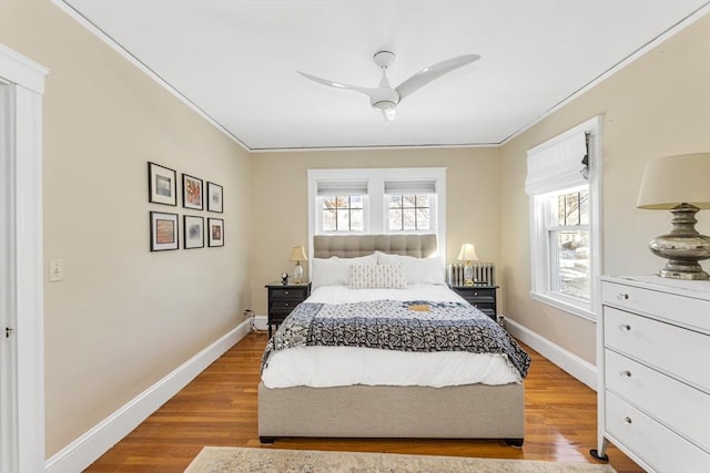 bedroom with crown molding, ceiling fan, and light hardwood / wood-style floors