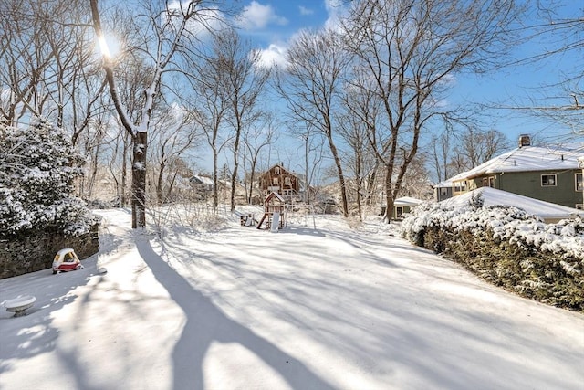 snowy yard with a playground