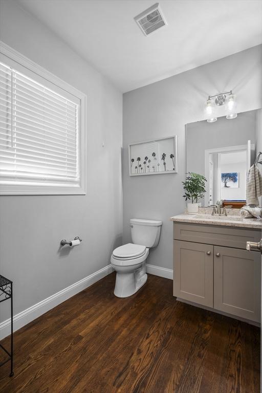 bathroom featuring vanity, hardwood / wood-style floors, and toilet