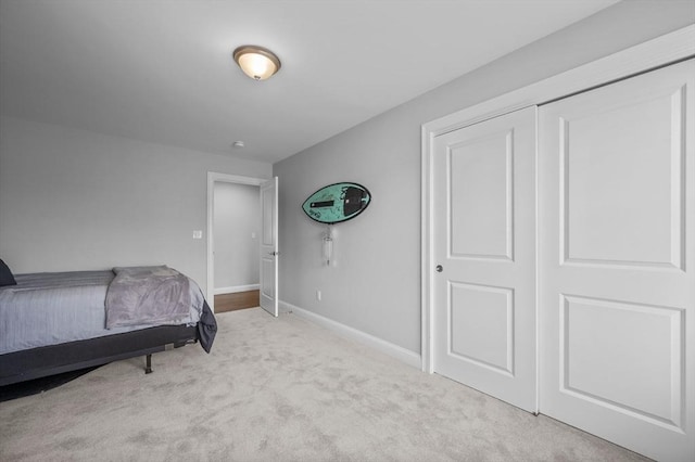 bedroom featuring light colored carpet and a closet