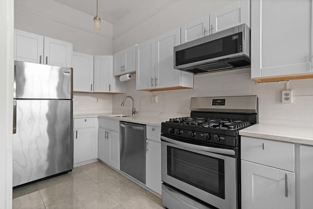 kitchen with backsplash, stainless steel appliances, white cabinets, and sink