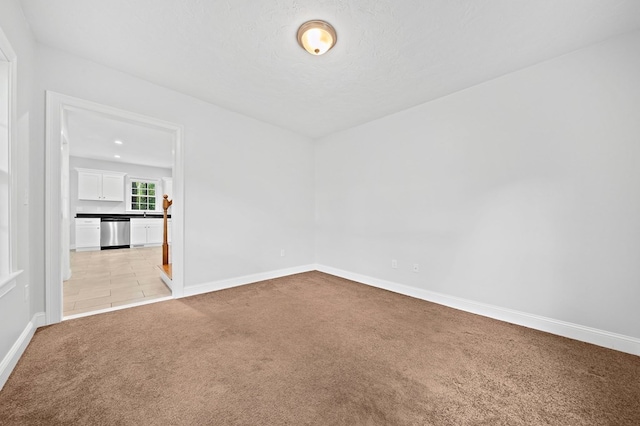 unfurnished room with light colored carpet