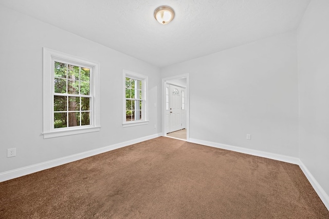 unfurnished room featuring light carpet