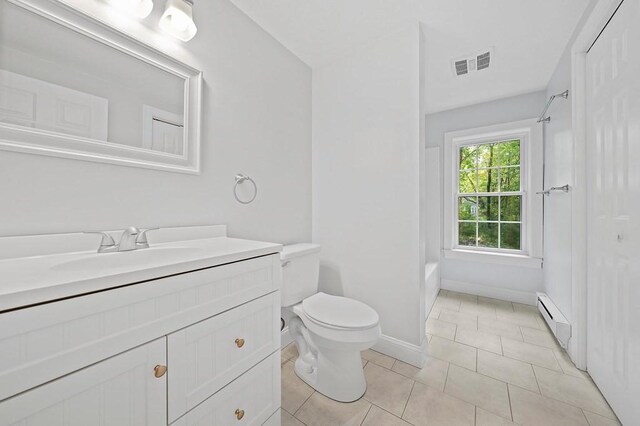 full bathroom with toilet, vanity, a baseboard radiator, tile patterned floors, and shower / tub combination