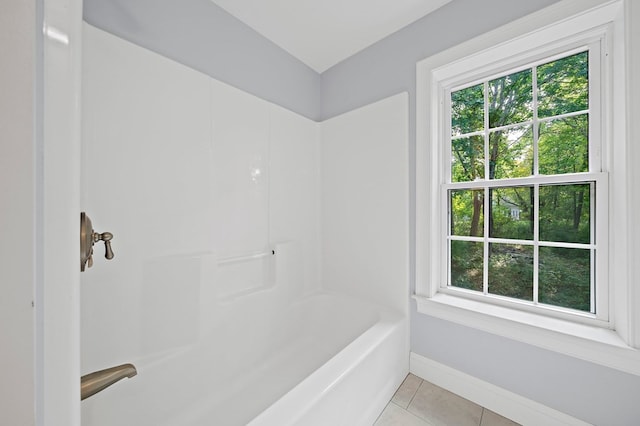 bathroom with shower / bathtub combination, tile patterned flooring, and a healthy amount of sunlight