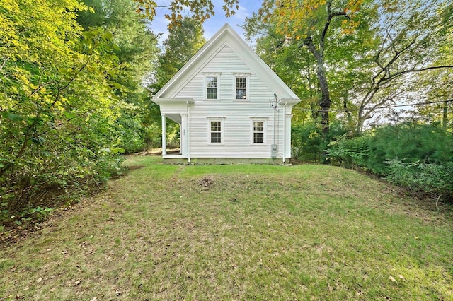 rear view of property with a lawn