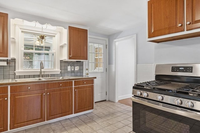 30 Brigham St, Hudson, MA 01749 - kitchen with stainless steel range with gas cooktop, healthy amount of natural light, and brown cabinets